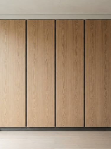 Straight-on architectural elevation of a floor-to-ceiling minimalist wardrobe, flawless vertical oak grain, deep charcoal linen shadows, 50mm lens