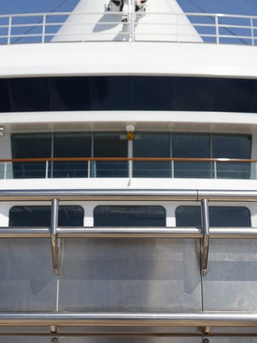 Crisp editorial photography of a modern cruise ship galley, bright natural daylight, stainless steel surfaces, 35mm lens, sharp focus