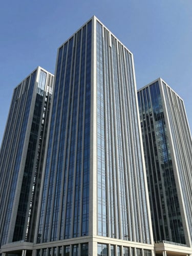 Wide shot of a pristine, modern Dubai commercial building exterior under clear blue sky, showcasing high-performance architectural glazing and clean structural lines.