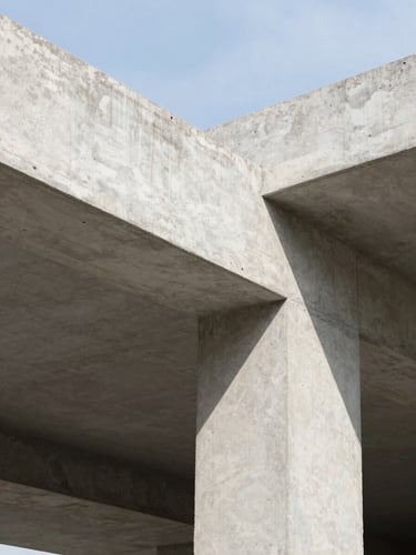 Architectural detail of clean concrete structure under natural daylight, sharp focus, 35mm lens