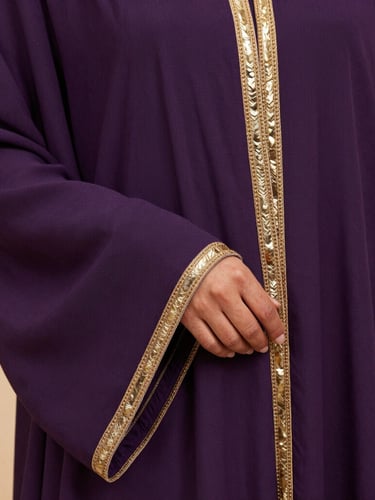 Medium-close shot of premium purple abaya fabric with soft gold trim, showcasing exquisite weave texture under diffused warm studio light.