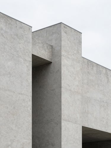 Abstract architectural concrete structure with clean lines and sharp angles, bright diffused daylight, neutral gray tones, 35mm photography