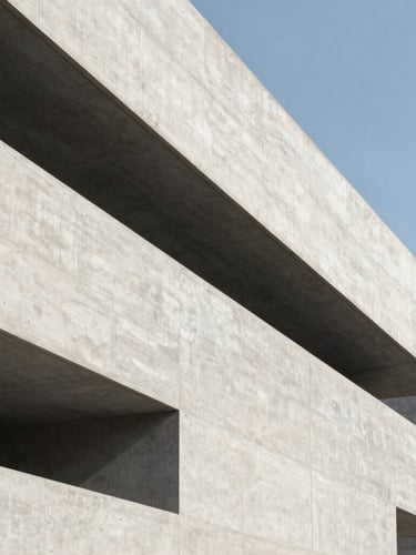 Abstract architectural geometry with sharp clean lines of a modern concrete building, captured in cool daylight with generous negative space.
