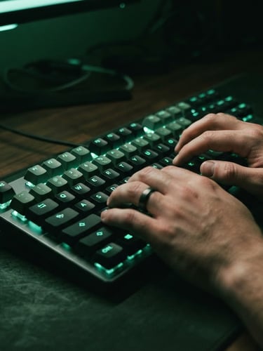Close-up of hands typing on a modern mechanical keyboard, illuminated by a sharp mint-green neon glow, deep forest green shadows.