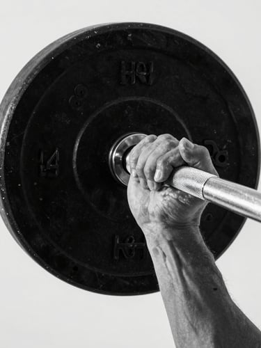 Close-up overhead study of hands gripping a barbell knurling, chalk dust settling on the bar, studio strobe lighting, stark white background, high contrast black and white tones