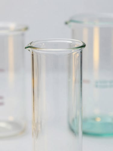 Macro close-up of high-end borosilicate glassware reflecting crisp studio light, subtle gold and teal backlighting, sharp focus, professional 35mm photography