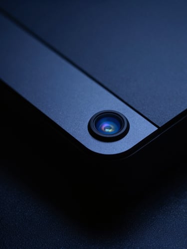 Macro shot of high-end consumer hardware, deep shadows, dramatic cool blue studio lighting, high contrast, 35mm