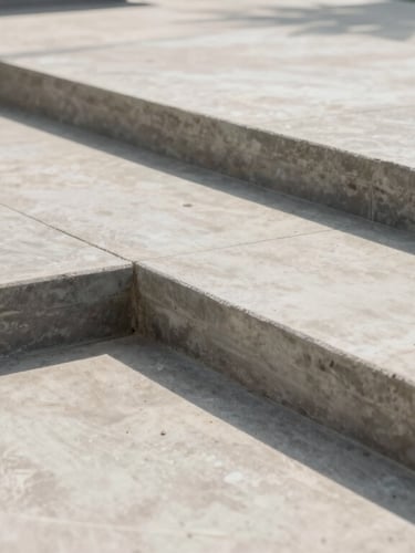 Low-angle architectural shot of a freshly finished concrete patio with clean brushed borders, bright daylight casting sharp textures.