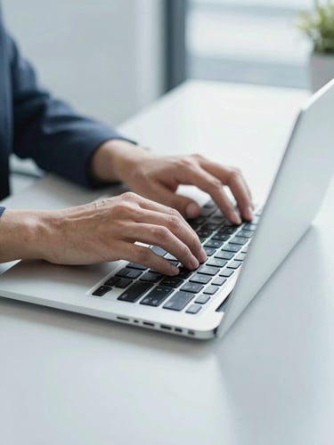 Crisp close-up of hands typing on a sleek laptop on a clean slate gray desk, bright neutral daylight, cool blue tones, professional corporate setting