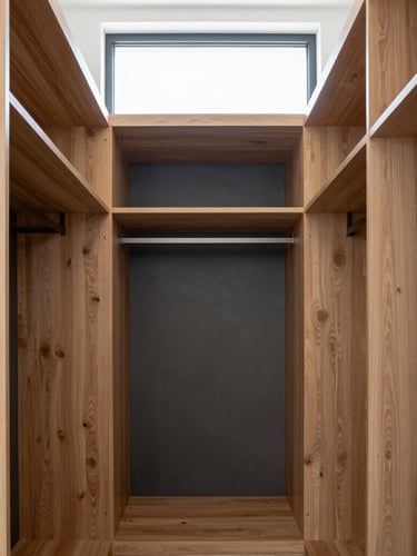 Straight-on architectural shot of a custom walk-in robe flush-fitted to the ceiling, warm oak and charcoal panels, bright natural window daylight, sharp detail, 35mm