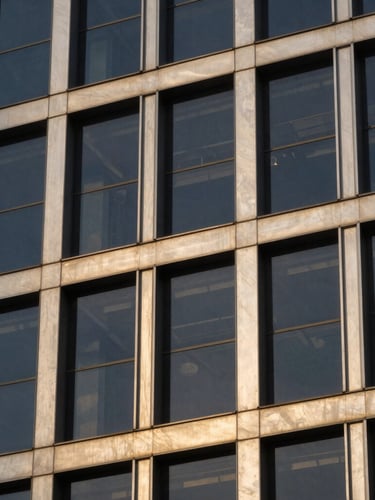Close-up of a modern architectural detail of Abuja's central business district, sharp window light reflecting off steel and glass, professional corporate aesthetic.