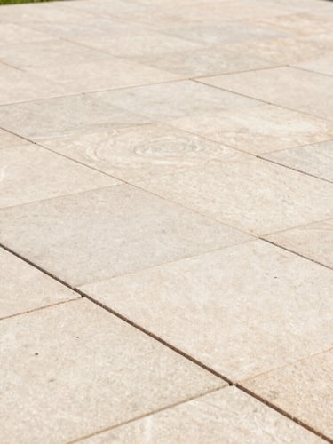 Close-up of a pristine, freshly pointed stone patio with clean joints, sharp focus, warm natural daylight