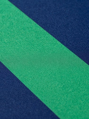 Close-up of high-precision sublimation printing on athletic fabric, vibrant colors merging under crisp studio lighting, textile texture visible, 35mm