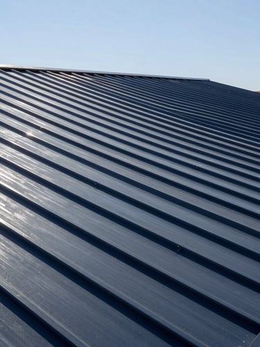 Crisp wide-angle architectural photograph of a premium residential metal roof in Hobbs, NM, under high-contrast bright desert sunlight, showcasing flawless alignment and clean steel gray seams.