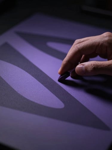 Elegant close-up of hands working on a high-end digital workspace, abstract architectural shadows, low-key dramatic lighting, soft violet and deep charcoal tones, cinematic dark editorial photography, 35mm lens.