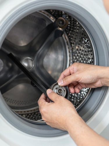 Close-up of a technician's hands carefully installing a genuine replacement belt inside a washing machine drum, bright utility lighting, professional technical focus