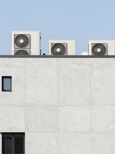 Minimalist modern concrete building facade, clean exterior architectural lines, bright daylight, high-end VRF outdoor units integrated seamlessly on a rooftop, 35mm architectural photography
