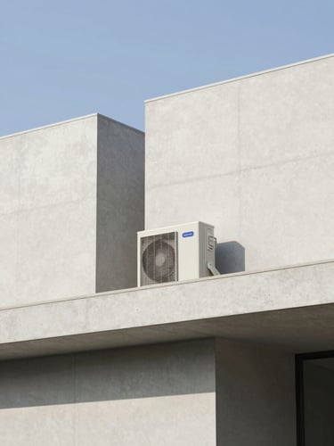 Wide-angle architectural shot of a minimalist concrete building facade under bright natural daylight, clean lines, high-end HVAC outdoor unit subtly integrated on a side ledge, 35mm photography
