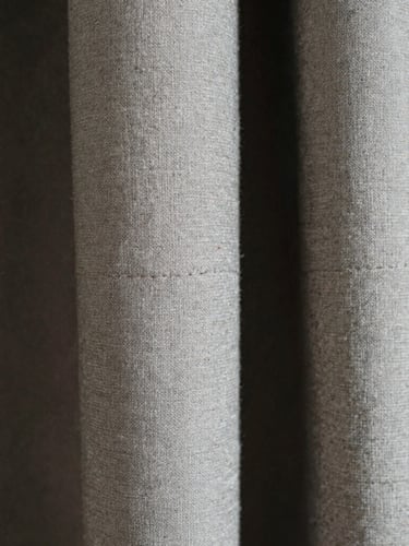 Extreme close-up macro photography, high-contrast natural light, the detailed weave of heavyweight Japanese cotton, raw textured seams, desaturated tones, 35mm