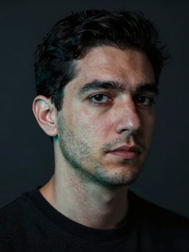 Close-up portrait of Matías, a technical founder in his 30s, looking directly at the camera. Minimalist dark workspace, low-key moody studio lighting with sharp electric-cyan highlights on his profile, deep shadows, professional and precise atmosphere.