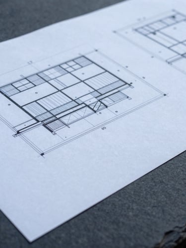 Extreme close-up of international planning documents and architectural blueprints on a slate table, cool overcast daylight, desaturated blue and charcoal tones, sharp focus