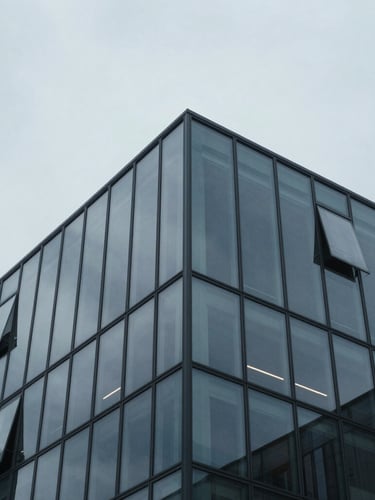 Extreme close-up of architectural blueprints and structural glass reflections, cool overcast daylight, desaturated blue and charcoal tones