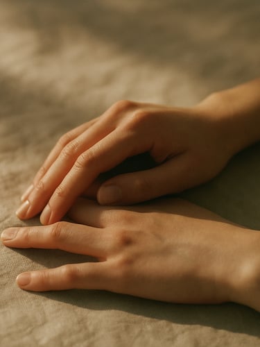Minimalist fine art photography of hands in repose on a soft beige linen cloth, warm natural afternoon sunlight casting soft shadows, muted olive tones, shallow depth of field, 35mm