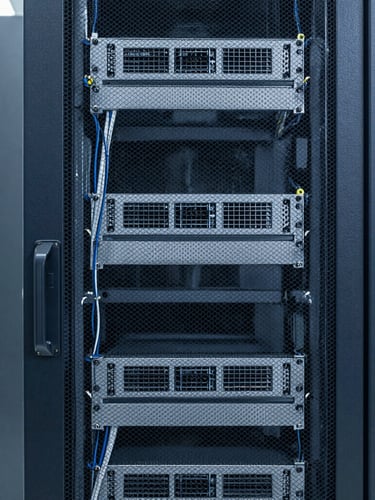 Straight-on structured shot of an enterprise server rack with neat, clean cabling, cool crisp indoor utility lighting, professional technical environment.