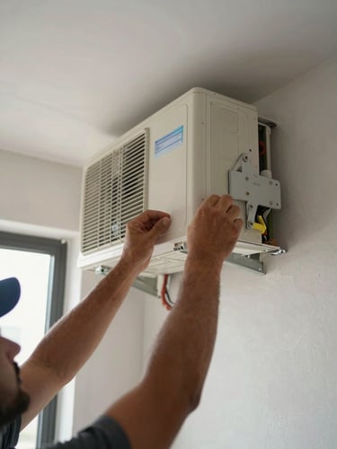 Close-up of a technician's hands mounting an AC indoor unit bracket on a plastered wall, visible refrigerant pipes and mounting hardware, natural daylight from a nearby window, real UAE apartment setting mid-installation