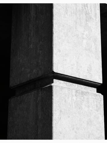 Stark high-contrast black and white architectural detail of a brutalist London concrete column, razor-sharp directional sunlight, deep shadows, 35mm film