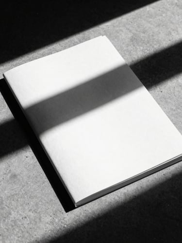Close-up of a starkly lit printed brand book on a raw concrete surface, hard directional shadows, high contrast black and white, minimalist composition