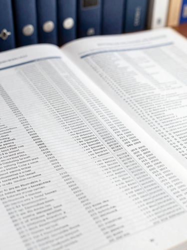 Close-up of printed academic journal pages, sharp focus on structured tables and scientific data, elegant library background, 35mm lens.