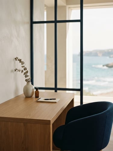 Minimalist high-end clinic interior overlooking soft coastal light, pearl white and warm sand tones, architectural negative space, warm editorial photography.