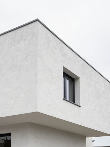 Architectural photography of a modern Belgian villa exterior, sharp geometric angles, pristine white textured crépi taloché facade, bright overcast daylight, 35mm lens.