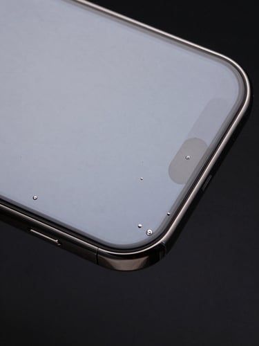 Extreme close-up, studio strobe lighting, smartphone screen with freshly applied military-grade protective film, zero bubbles, perfect edge adhesion, optical clarity with no distortion, display fully visible through film, high-contrast black background, after installation documentary proof