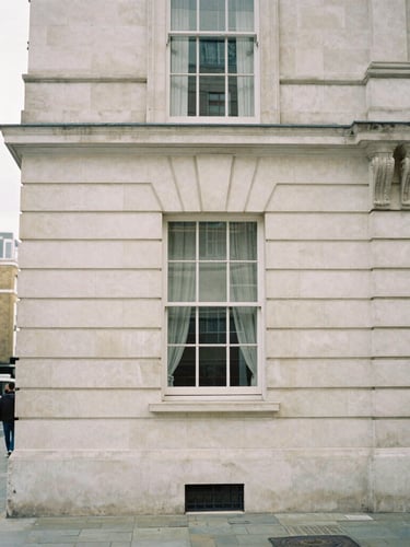 A minimalist London streetscape near Great Portland Street, quiet morning, soft overcast daylight, architectural stone details, 35mm film.