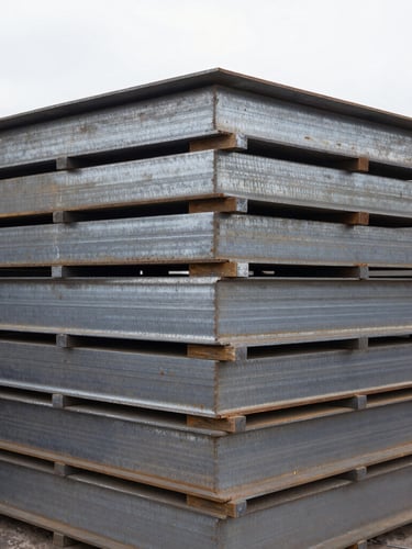 Close-up of heavy industrial scale with stacked steel plates, natural overcast daylight, industrial documentary photography