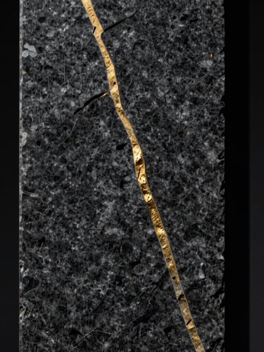 Extreme close-up portrait of a dark, textured basalt stone column with a single sharp, polished gold vein cutting vertically through it. Chiaroscuro lighting, deep shadows, sterile black background.