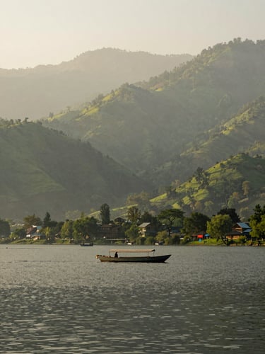 A peaceful view of Nainital lake surrounded by green hills, a traditional rowing boat on the water, soft morning daylight, misty mountain atmosphere