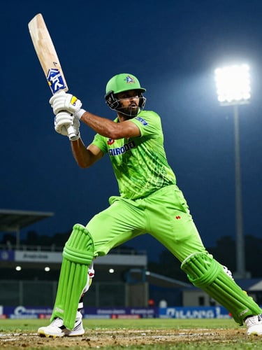Dynamic low-angle action shot of an IPL batsman mid-stroke under intense stadium floodlights, deep midnight blue and neon green tones, 35mm lens