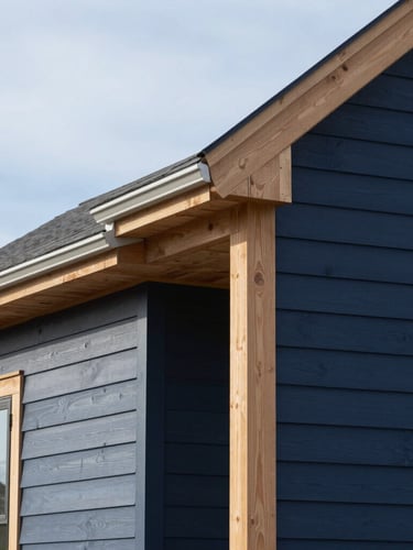 Crisp architectural photo of a finished home exterior with clean siding lines against a bright morning New England sky, sharp focus, 35mm lens