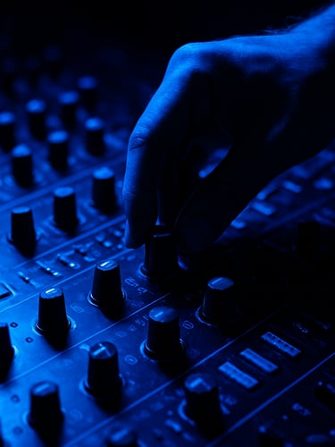 Close-up of a DJ's hand adjusting a knob on a high-end mixing console, vibrant electric blue light reflecting on the equipment, deep shadows, high contrast, technical detail, 35mm lens.