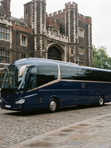 Modern luxury coach parked in front of a historic UK landmark, bright overcast daylight, deep navy and gold tones, crisp architectural framing, 35mm
