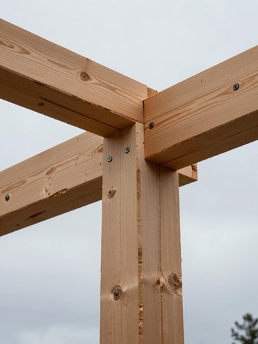 Close-up of exposed Douglas-fir timber framing against a soft overcast Oregon sky, clean structural joints and heavy bolts visible.