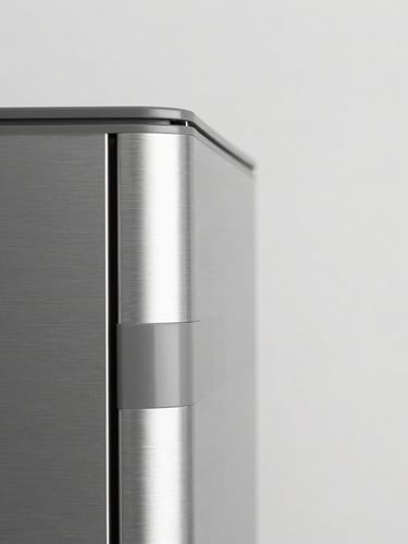 Close-up detail shot of brushed metal and matte plastic components of a modern home appliance, high-key lighting, sharp focus, neutral background
