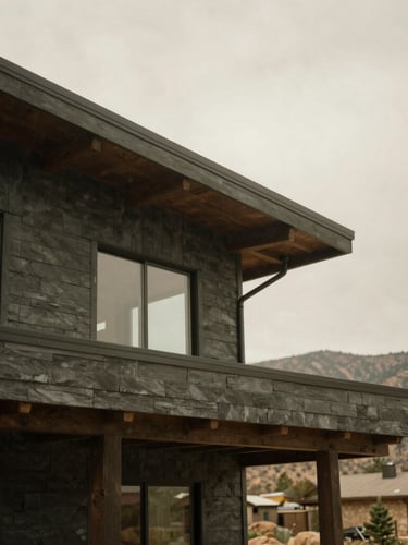 Architectural detail of a modern mountain home in Kamas, soft overcast daylight, muted slate and charcoal tones, 35mm