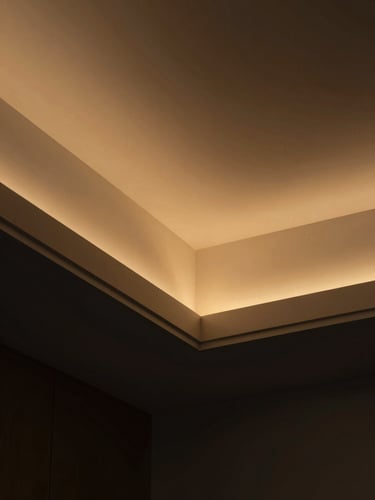 Close-up of premium architectural finish, clean drywall lines, warm golden-hour interior lighting, dark charcoal background, 35mm editorial photography