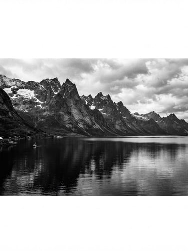 Wide panoramic black and white Norwegian fjord landscape, dramatic high contrast, sharp mountain peaks, deep shadows, minimalist, with vast negative space, 35mm