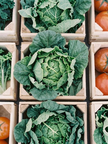 Overhead flat-lay of raw wooden crates overflowing with fresh seasonal leafy greens and heirloom tomatoes, soft overcast daylight, organic textures.