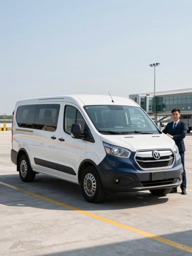 A clean late-model navy shuttle van parked at Buffalo airport terminal curb under bright morning daylight, professional driver standing nearby, crisp commercial photography style